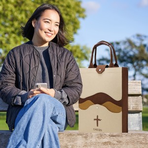 Vertical shot of beautiful brunette woman sitting on bench with smartphone, waiting for someone, using mobile appliation