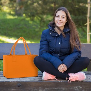 Smiling pretty sporty woman posing at camera on bench