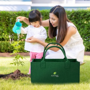 Asian family mother and kid daughter plant sapling tree and wate
