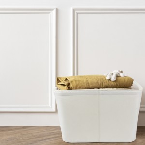 Rattan laundry basket in a white room